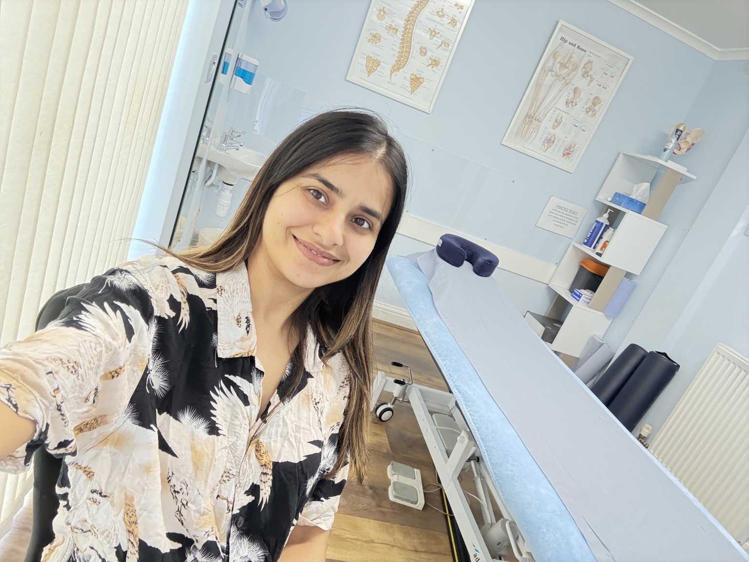 Mamta Lamba smiling in a physiotherapy treatment room